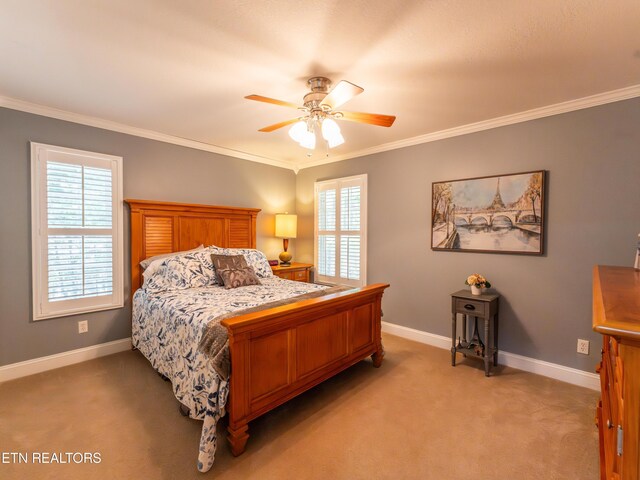 bedroom featuring ornamental molding, ceiling fan, light colored carpet, and multiple windows