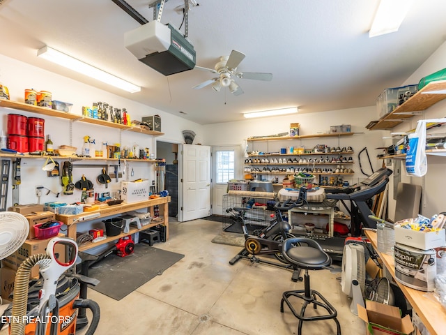 garage with ceiling fan, a garage door opener, and a workshop area