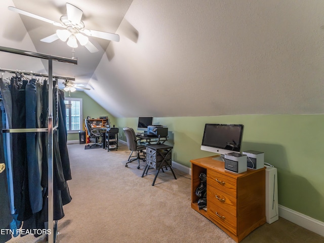 carpeted home office with vaulted ceiling and ceiling fan