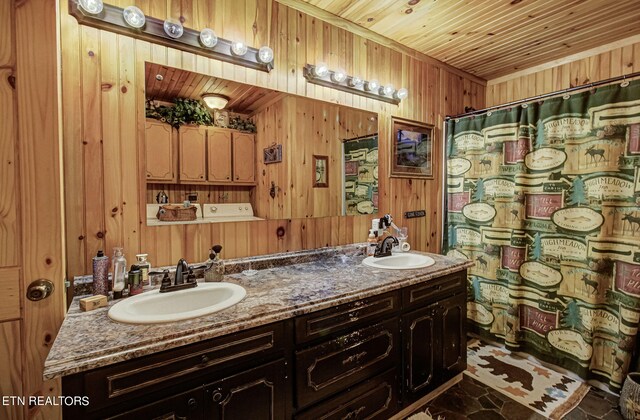 bathroom with wooden ceiling, wooden walls, vanity, and walk in shower