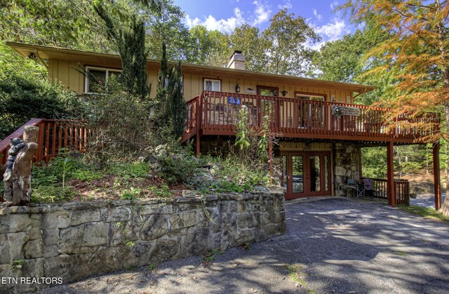 view of front of home with french doors and a deck