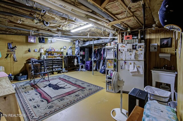 basement featuring white fridge