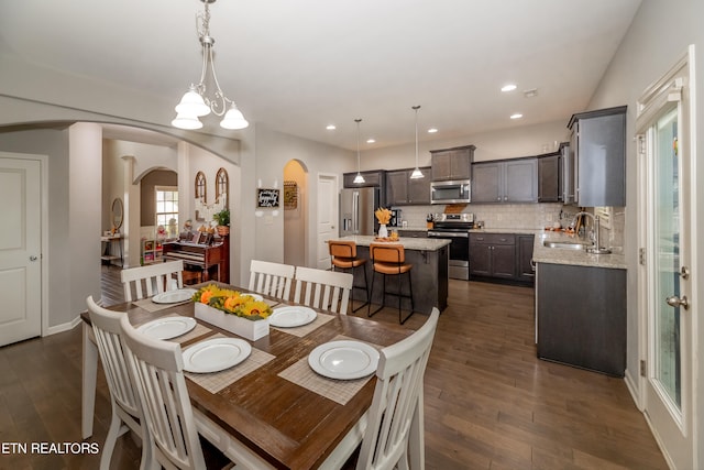 dining area featuring an inviting chandelier, dark hardwood / wood-style flooring, and sink