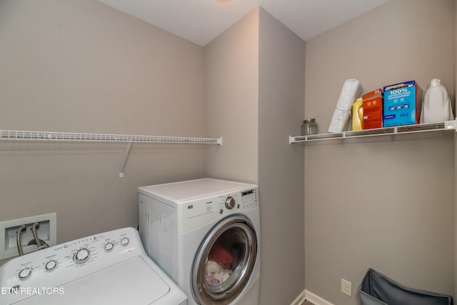 clothes washing area with separate washer and dryer