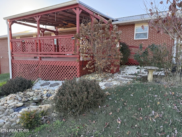 exterior space featuring a wooden deck and a yard