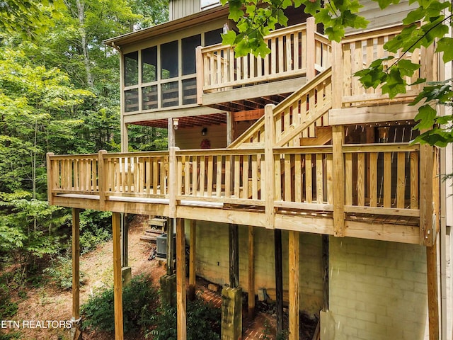 exterior space featuring a sunroom and central air condition unit