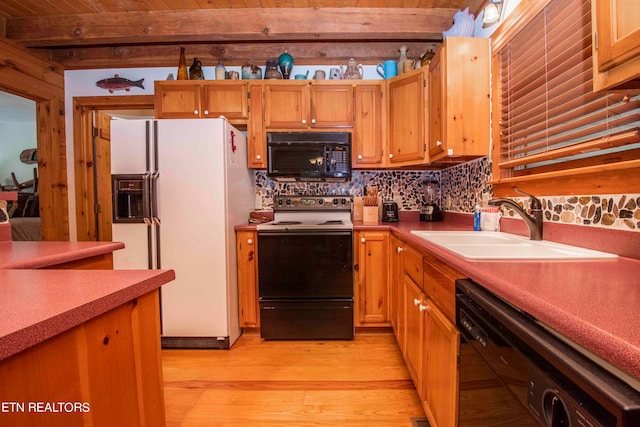 kitchen with sink, beam ceiling, tasteful backsplash, black appliances, and light wood-type flooring