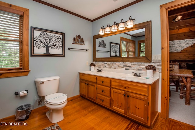 bathroom featuring hardwood / wood-style floors, vanity, toilet, and ornamental molding