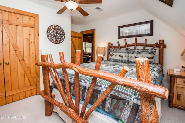 bedroom featuring ceiling fan, lofted ceiling, and carpet