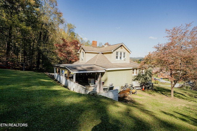 view of side of home with a lawn