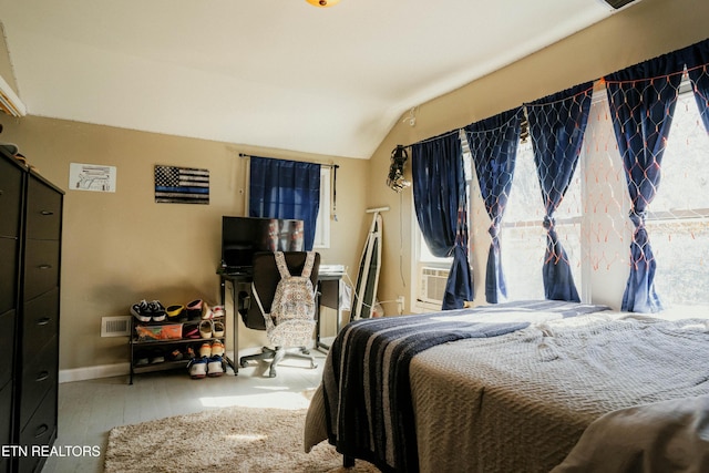 bedroom featuring lofted ceiling and light hardwood / wood-style flooring