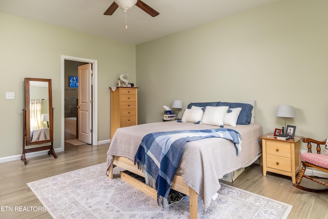 bedroom with light hardwood / wood-style floors, ensuite bath, and ceiling fan