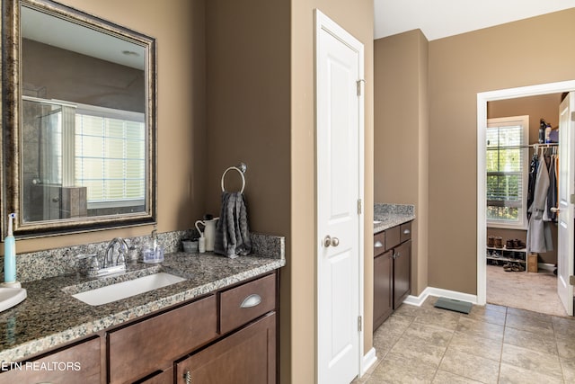 bathroom with vanity, tile patterned flooring, and an enclosed shower