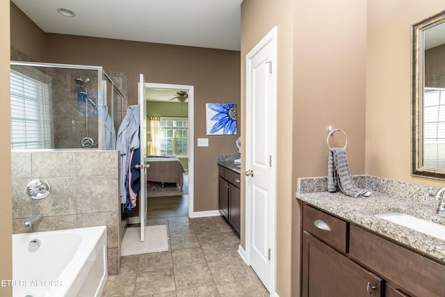 bathroom with tile patterned flooring, ceiling fan, vanity, and separate shower and tub