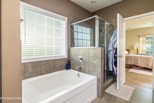 bathroom with ceiling fan, plus walk in shower, and hardwood / wood-style flooring