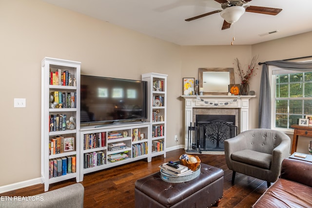 living room featuring ceiling fan and dark hardwood / wood-style flooring