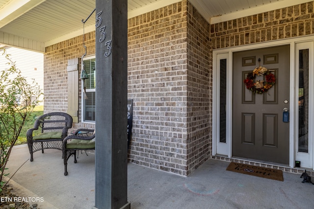 view of exterior entry featuring a porch