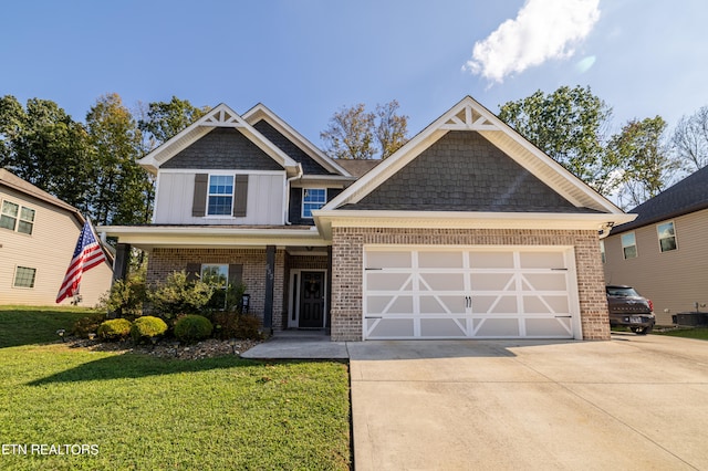 craftsman house with a front yard, a garage, and central AC unit