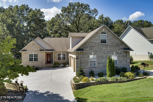 view of front facade with concrete driveway, a front lawn, crawl space, and brick siding