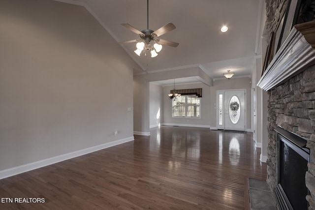 unfurnished living room featuring baseboards, dark wood finished floors, crown molding, a stone fireplace, and ceiling fan with notable chandelier