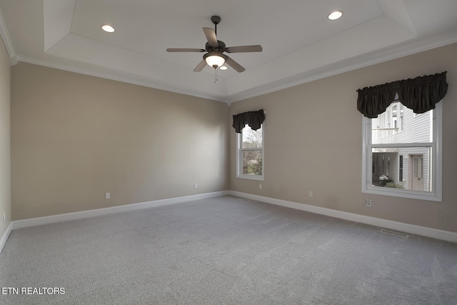 carpeted empty room with ceiling fan, baseboards, a raised ceiling, and recessed lighting