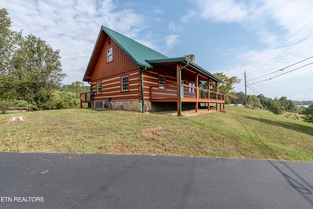 exterior space with a deck and a front yard