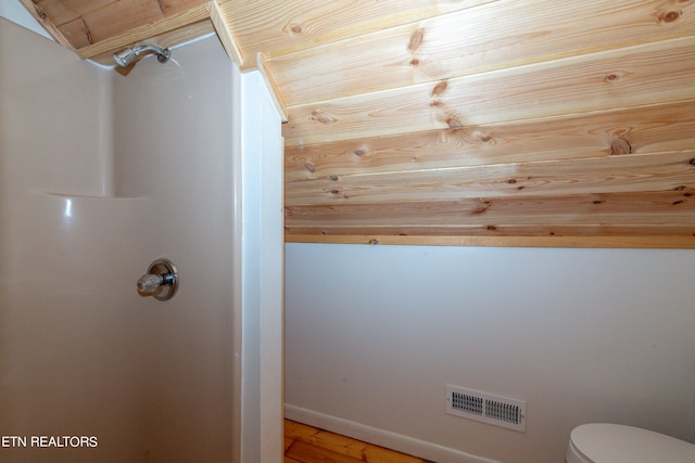 bathroom with wood-type flooring, lofted ceiling, wooden ceiling, and toilet