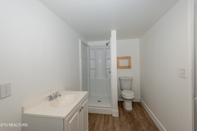 bathroom with walk in shower, wood-type flooring, vanity, and toilet