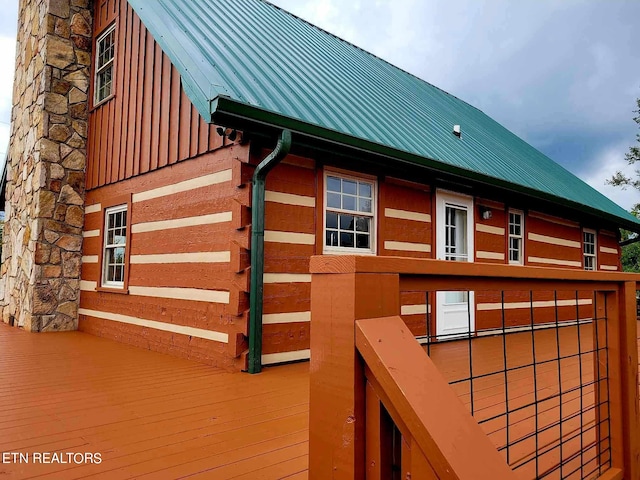 view of home's exterior with a wooden deck