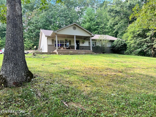 view of front facade with a front lawn and covered porch