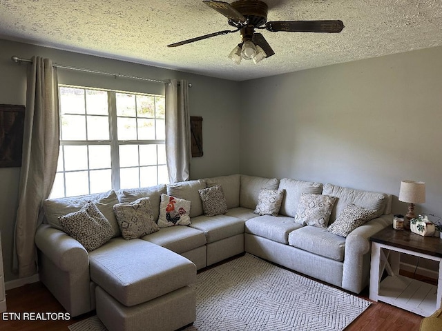 living room featuring a textured ceiling, ceiling fan, and hardwood / wood-style flooring