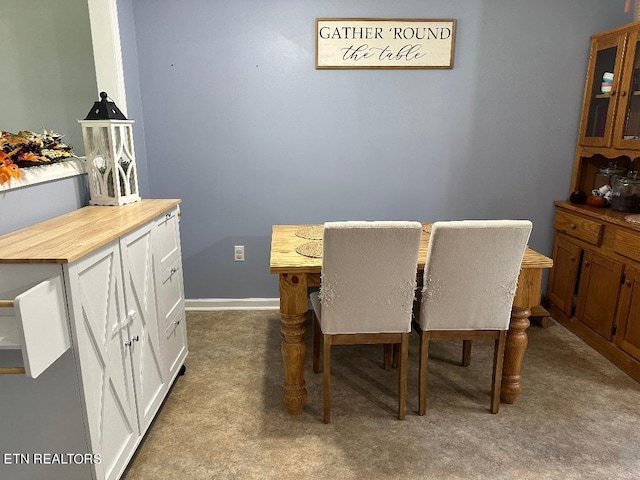 dining space featuring light colored carpet