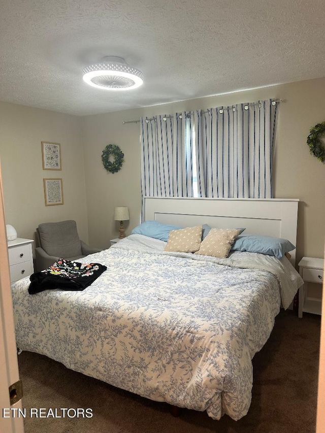 carpeted bedroom featuring a textured ceiling