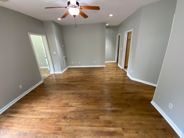 unfurnished room with ceiling fan and dark hardwood / wood-style flooring