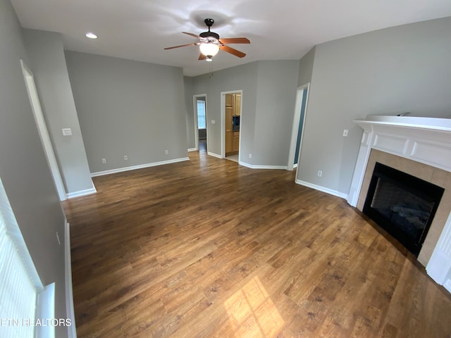 unfurnished living room featuring dark hardwood / wood-style floors, plenty of natural light, and ceiling fan