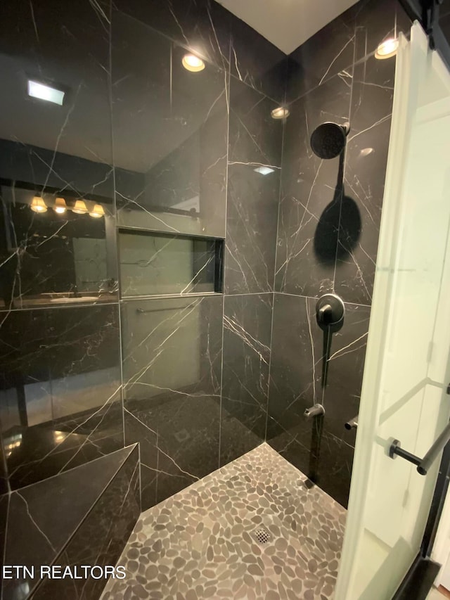 bathroom with a tile shower