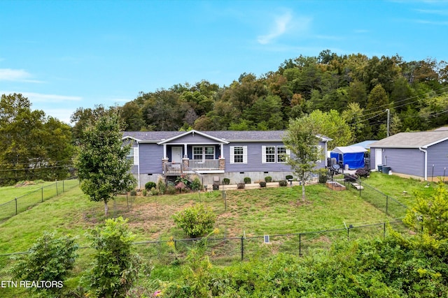 view of front of house with a front yard and a deck