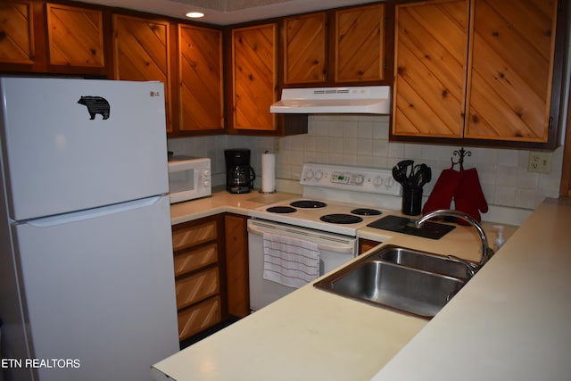 kitchen with sink, white appliances, and decorative backsplash