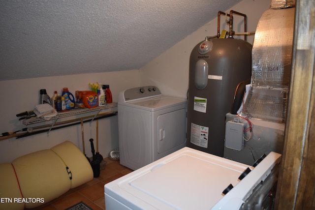 clothes washing area featuring a textured ceiling, washer and clothes dryer, light tile patterned flooring, and electric water heater