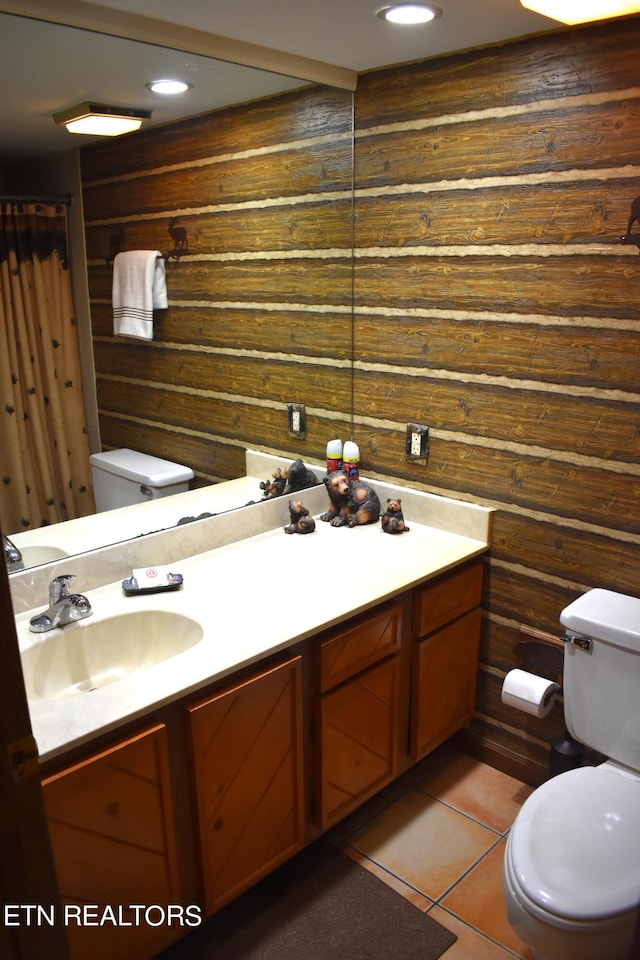 bathroom with wood walls, vanity, and toilet