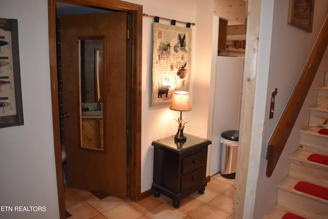 hallway featuring light tile patterned flooring and sink