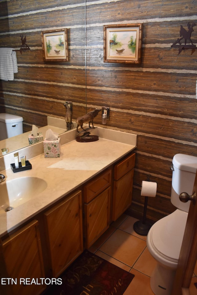 bathroom featuring wood walls, vanity, and toilet