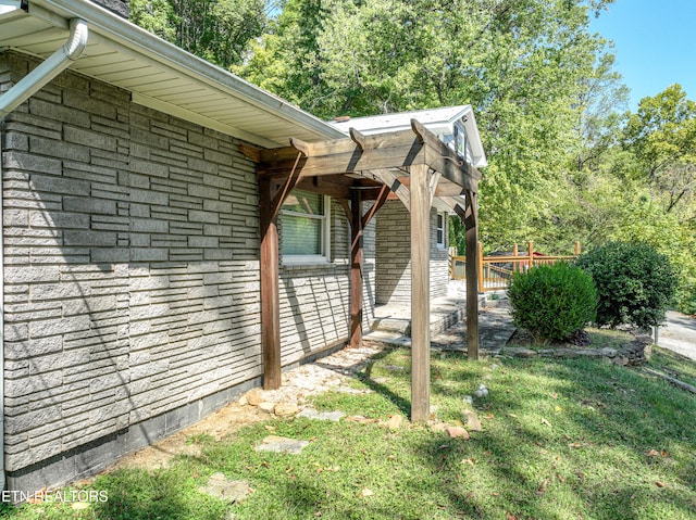 view of side of property with a lawn