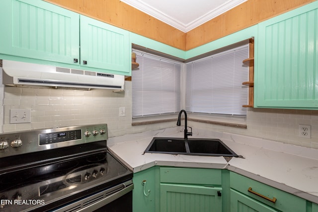 kitchen with ornamental molding, sink, tasteful backsplash, green cabinetry, and electric stove