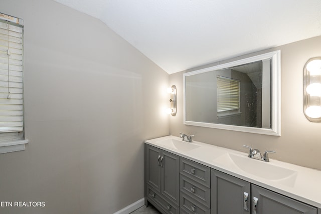 bathroom featuring lofted ceiling and vanity