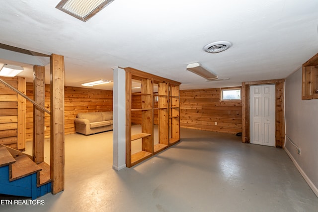 basement featuring wood walls