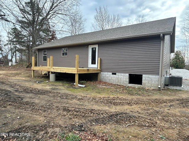 rear view of property featuring central AC and a deck