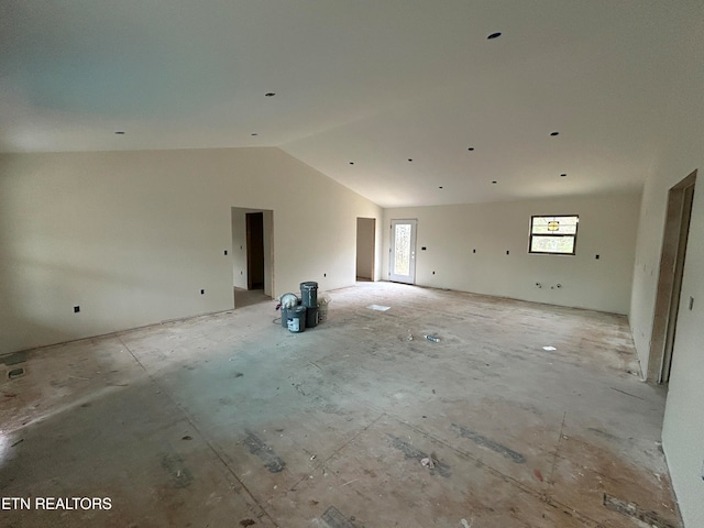 unfurnished room with vaulted ceiling