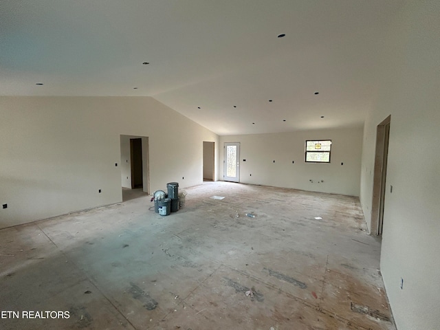 unfurnished room with lofted ceiling