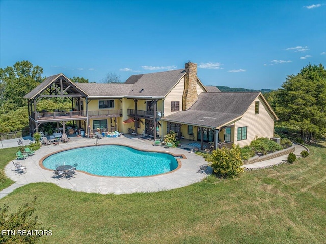 view of pool with a yard and a patio area